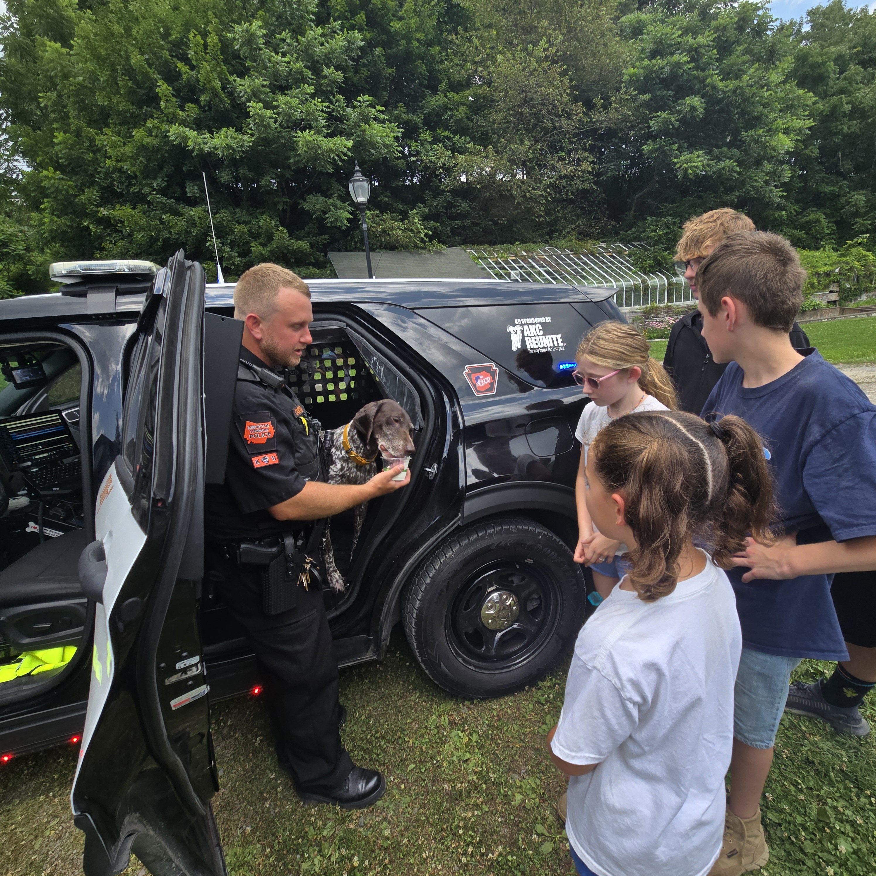 Kingston police and Summer Camp students with Dilly the Dog